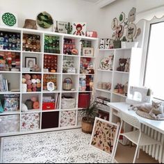 a room filled with lots of different types of crafting supplies on shelves next to a window