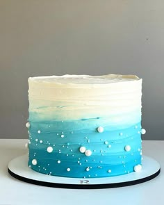 a blue and white ombrella cake on a plate