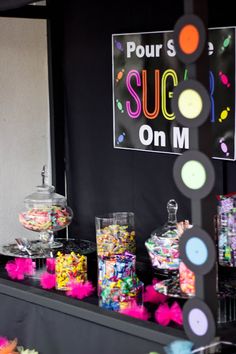 the candy bar is decorated with colorful candies and lollipops on display