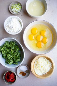 the ingredients to make this dish include eggs, cheese and spinach leaves in bowls