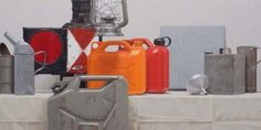 several different types of gas cans on a table