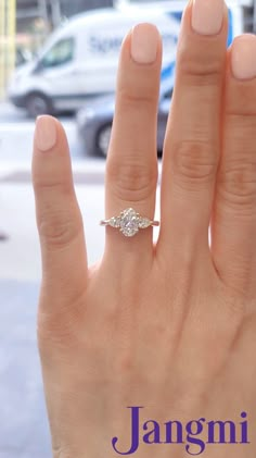 a woman's hand with a ring on it and the words janomi written below