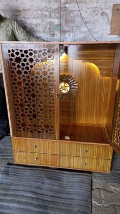 an old fashioned wooden cabinet with intricate carvings on it's sides and doors open