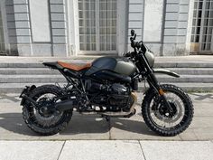 a motorcycle is parked on the sidewalk near some steps and stairs in front of a building