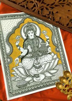 an ornately decorated card with the image of hindu god on it and gold accents