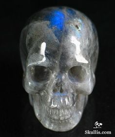 a glass skull with blue markings on it's face