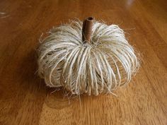 a rope ball sitting on top of a wooden floor