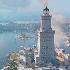 an aerial view of a tall tower with a clock on it's side and water in the background