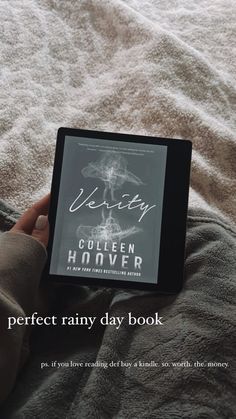 someone is reading a book on their bed with the caption perfect rainy day book