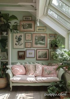 a living room filled with lots of plants and framed pictures on the wall above it