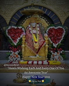 an image of the hindu god sitting in front of a statue with flowers on it