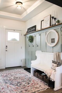 a living room with a white couch, rug and shelves on either side of the door