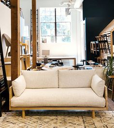 a living room filled with furniture and lots of windows