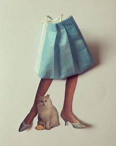 a cat sitting next to a woman's legs wearing high heels and a blue skirt