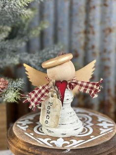 a small wooden angel sitting on top of a table