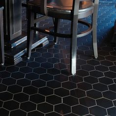 a kitchen with black and white tile flooring