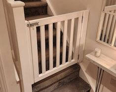 stairs leading up to the second floor in a home with white railings and wood steps