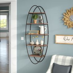 a living room with blue walls and a white chair in front of a wall shelf