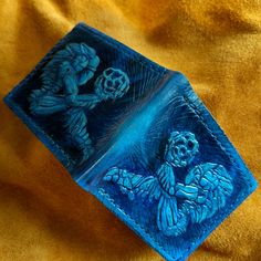 a blue glass box with an image of two people on it sitting on a yellow cloth