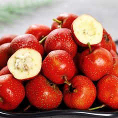 a bowl filled with lots of red fruit