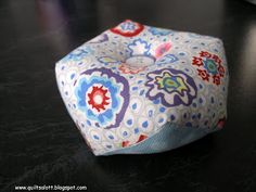 a square shaped cushion sitting on top of a table