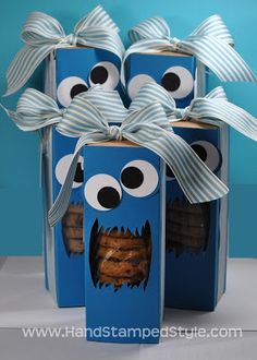 two blue boxes decorated with googly eyes and cookies