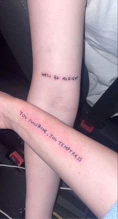 two people with tattoos on their arms that say, we'll be alright you ruined