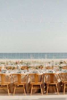 a long table set up on the beach for an event