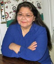 a woman sitting at a table with her arms crossed