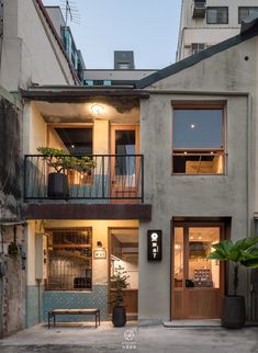 an apartment building with two balconies on the second floor