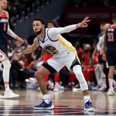 a basketball player is about to pass the ball in front of other players and fans