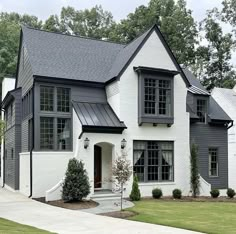 a white and black house with lots of windows