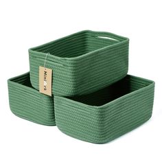 two green storage baskets with tags on them