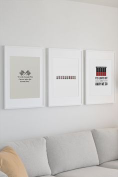 three framed art pieces hang on the wall above a couch in a white living room