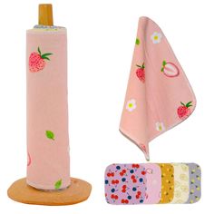 the pink umbrella has strawberrys on it and is next to four different colored napkins