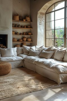 a large white couch sitting in front of a window