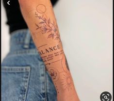 a woman with a tattoo on her arm that reads balance and has flowers in it