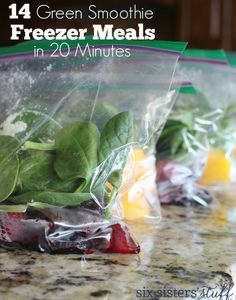 there are many fruits and vegetables wrapped in plastic bags on the counter top with lemons, watercretches, and spinach