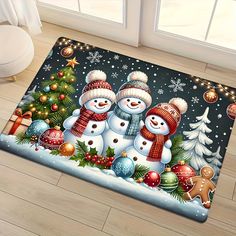 two snowmen standing next to each other in front of a christmas tree on a door mat