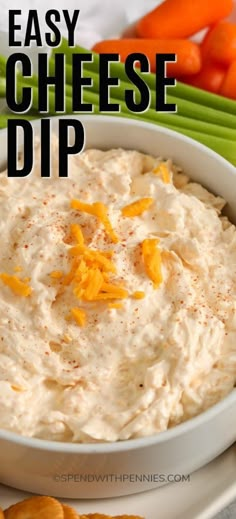 an easy cheese dip in a bowl with carrots and celery on the side