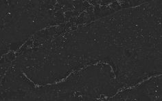 black marble textured with white speckles in the dark night sky, as seen from above