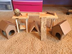 some cardboard boxes are stacked on top of each other in front of a cat house