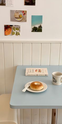 a table with a book, plate and cup on it