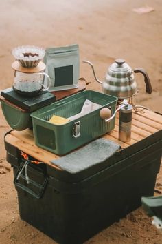 there are many different items on the sand near each other, including an oven and coffee pot