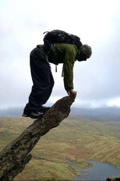 a man standing on top of a tree branch