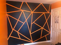 an orange and black wall with lines painted on it