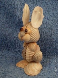 a ceramic rabbit figurine sitting on top of a blue cloth