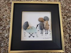 some rocks are placed in a black frame