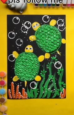 an art project with bubbles and fish on it