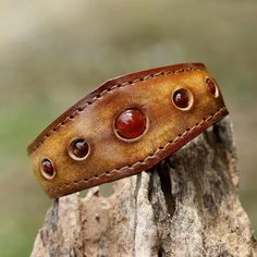 Carnelians Are Displayed Along A Leather Cuff That Has A Stainless Steel Wire Inside So It Can Be Adjusted To Allow For A Wide Range Of Wrist Sizes. Carnelian Is Known As A Stone Of Motivation And Endurance, Leadership And Courage. Carnelian Is An Orange-Colored Variety Of Chalcedony, A Mineral Of The Quartz Family. 0.65 Oz 7" L (End To End) X 1.2" W Leather, Carnelian Natural Carnelian Stone Leather Bracelet With Stone, Diy Leather Projects, Leather Craft Patterns, Handmade Leather Bracelets, Leather Wristbands, Polymer Clay Necklace, Clay Necklace, Leather Cuffs Bracelet, Leather Gifts